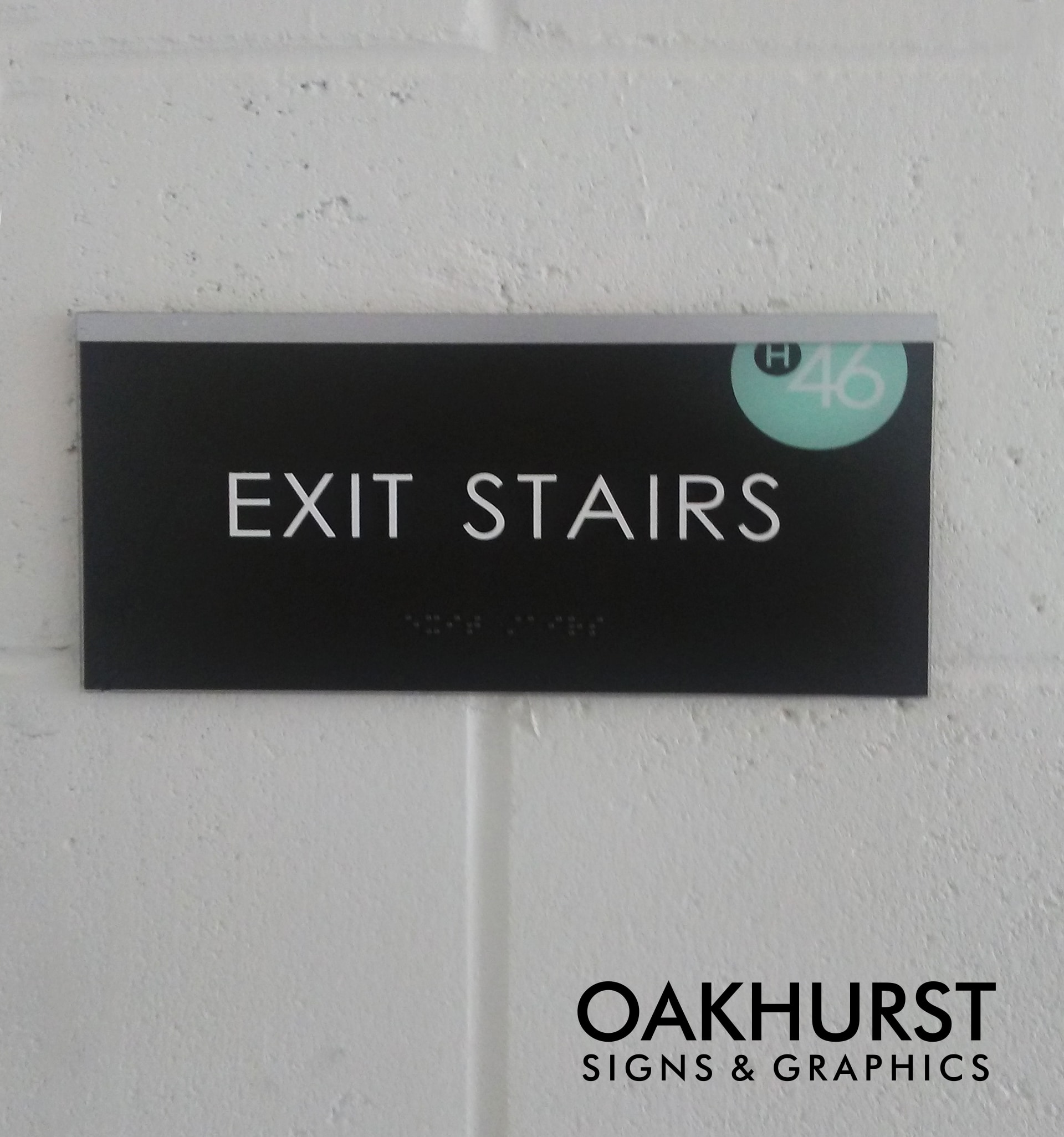 ADA signage labeling "Exit Stairs" external