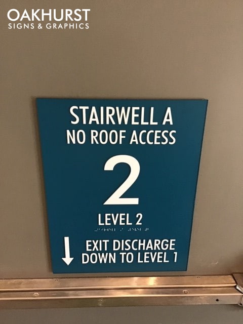 Stairwell access wayfinding ADA sign mounted on wall