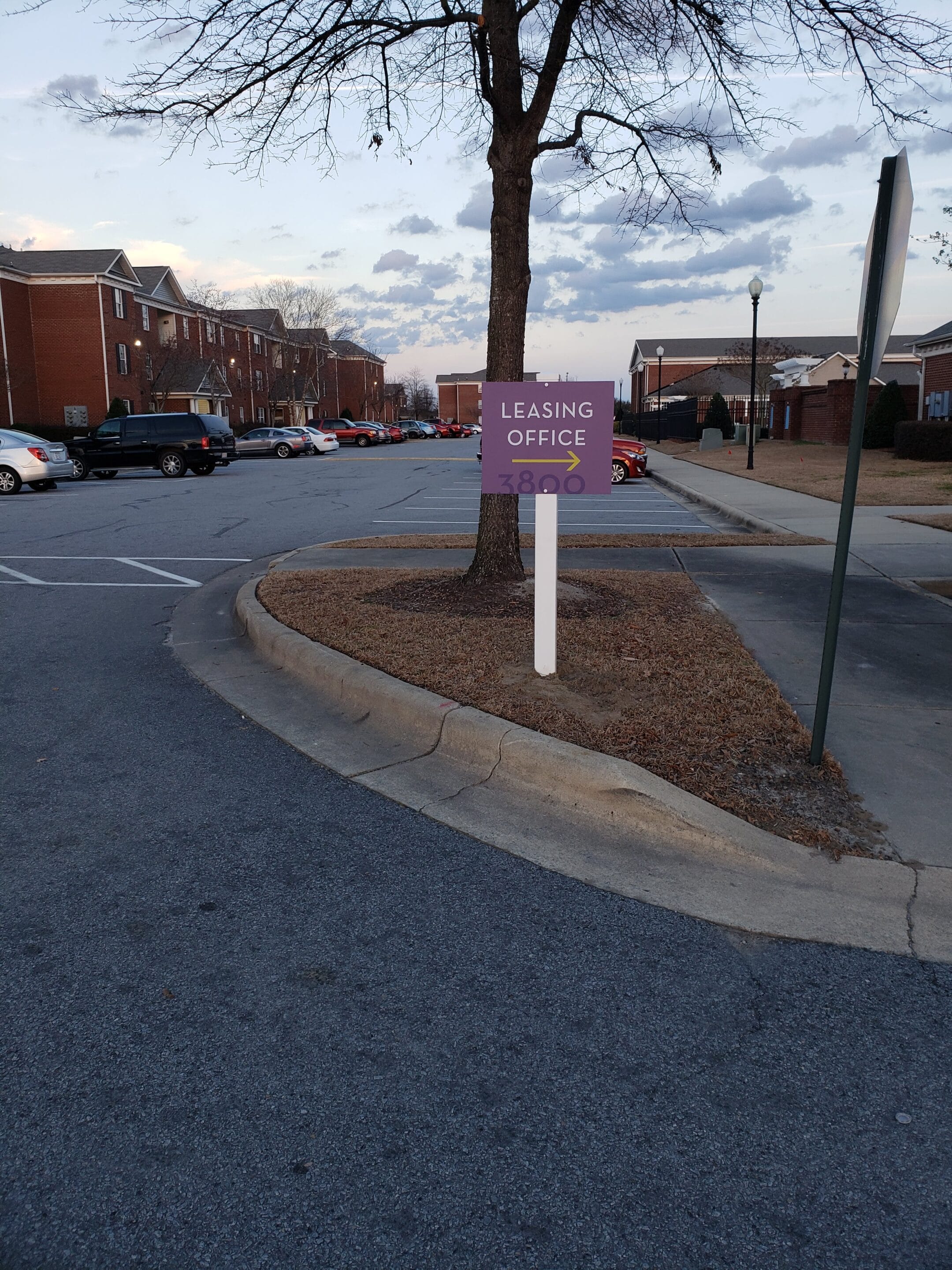 Leasing office sign with arrow on post