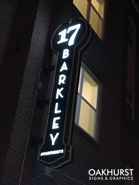 17 Barkley Apartments Blade Sign, illuminated at night