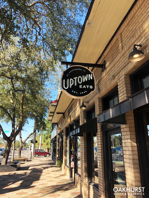 Distant view of Uptown Eats hanging signage