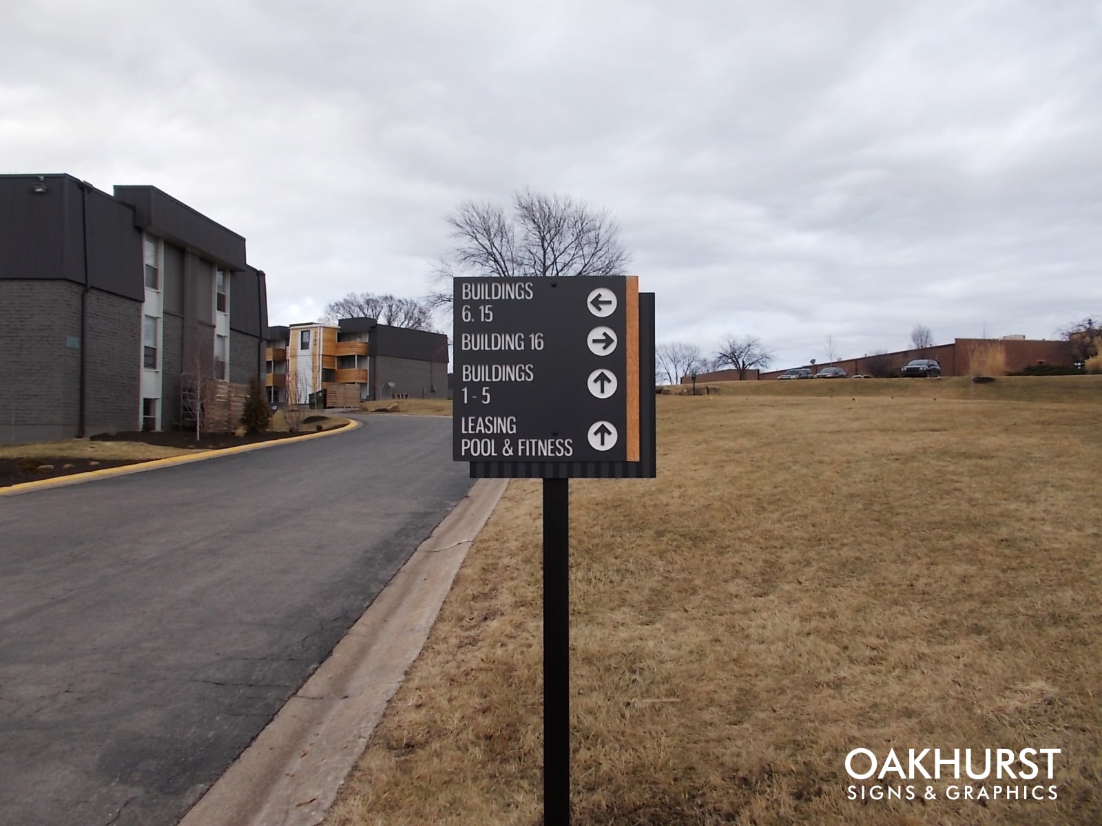 Directional sign on post at apartment complex