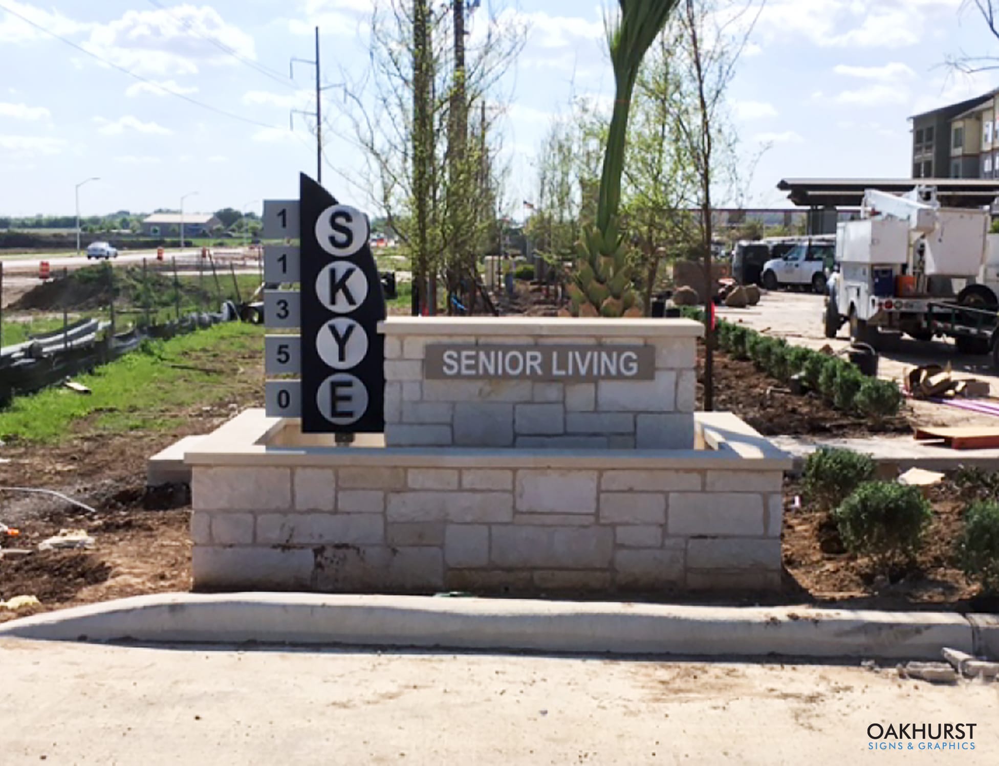 Distant view of Skye Senior Living monument signage before landscaping