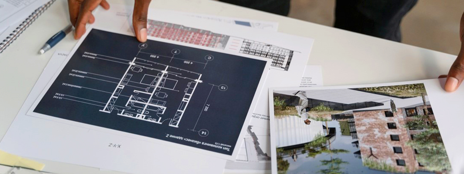 general contractors reviewing architectural signage blueprints