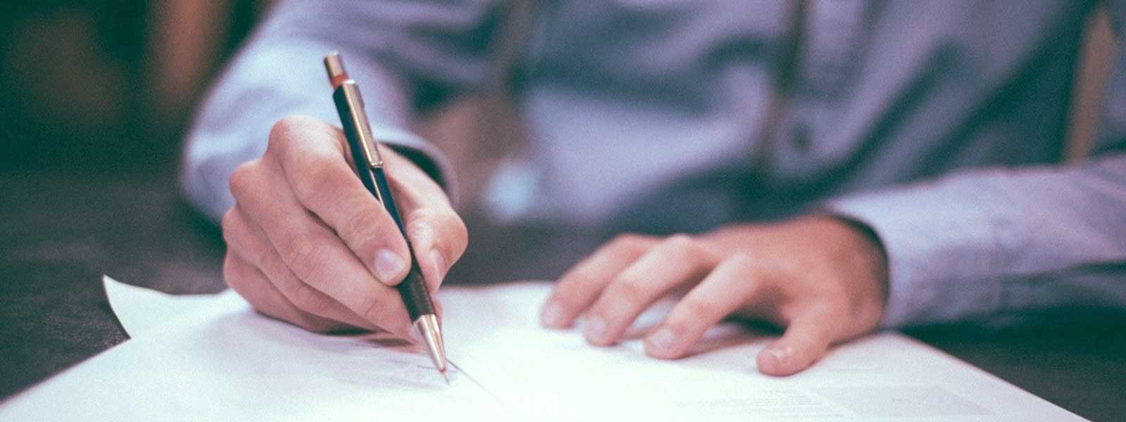 Hands of a person going over permitting paperwork